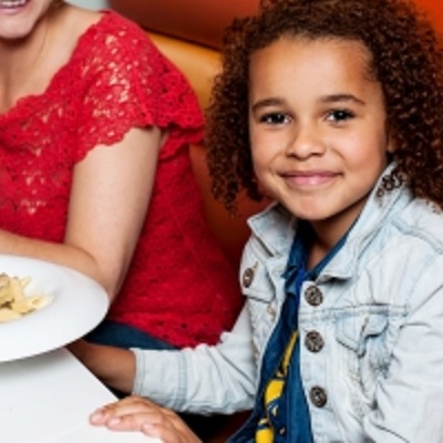 Little Girl Enjoying Dinner With Her Mom by stockimages